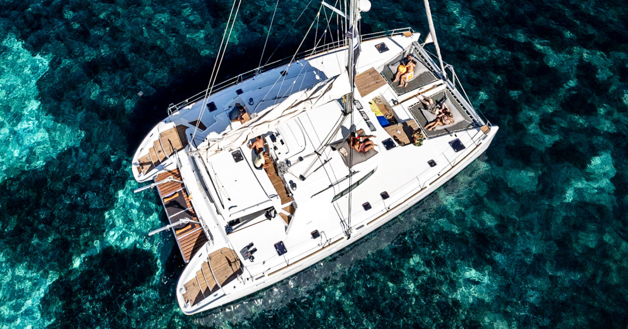 Luxury catamaran in Mallorca sailing along the island’s turquoise coastline