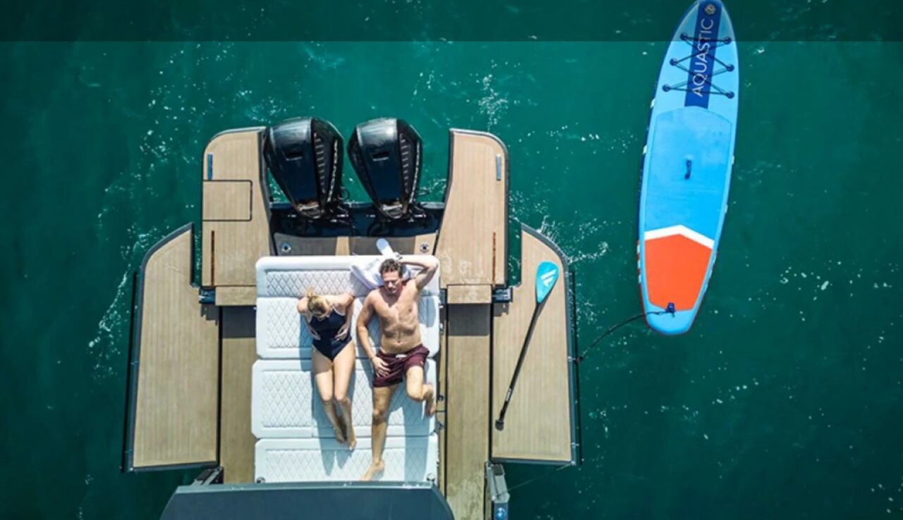 Aerial view of a luxury yacht cruising along the turquoise coastline of Mallorca
