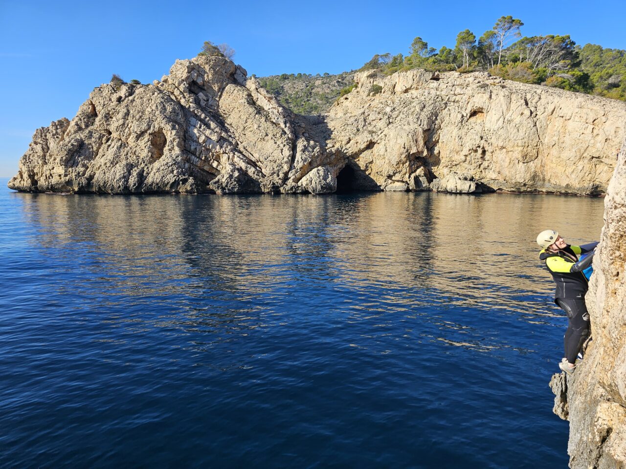 Man coasteering in Mallorca jumping into the sea during an adventure coastline tour