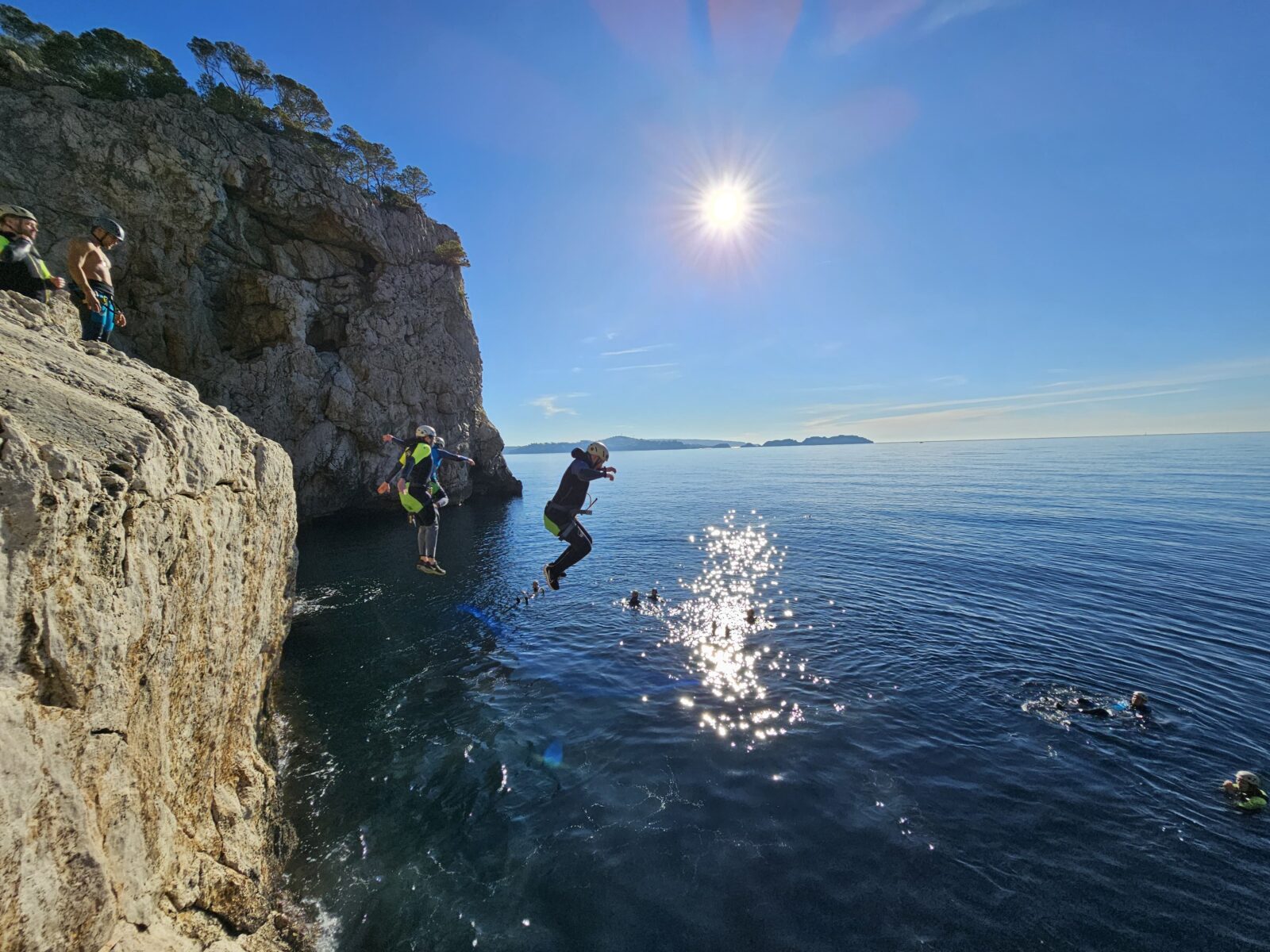 Man cliff jumping into the sea during a coasteering adventure tour in Mallorca