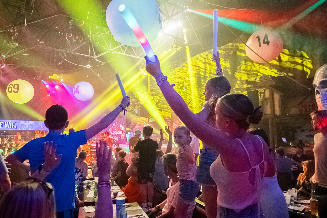 Children and parents dancing together at the Gringos Family Party Rave in Mallorca