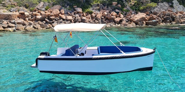 no licence boat floating in crystal clear waters in mallorca
